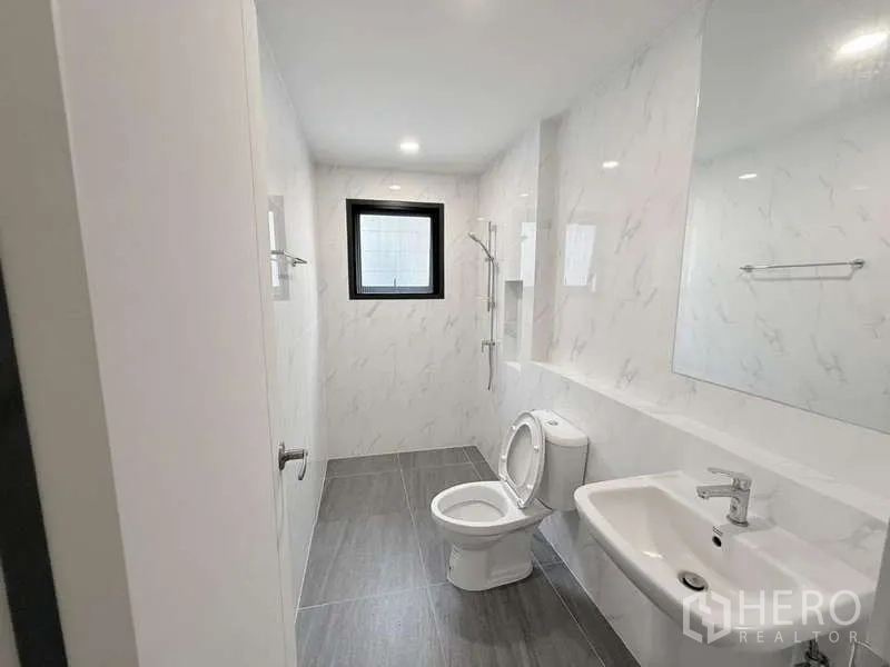 Detached House for sale in Bang Phli, Samut Prakan - Bright upstairs bathroom with walk-in shower, white tiles and window.