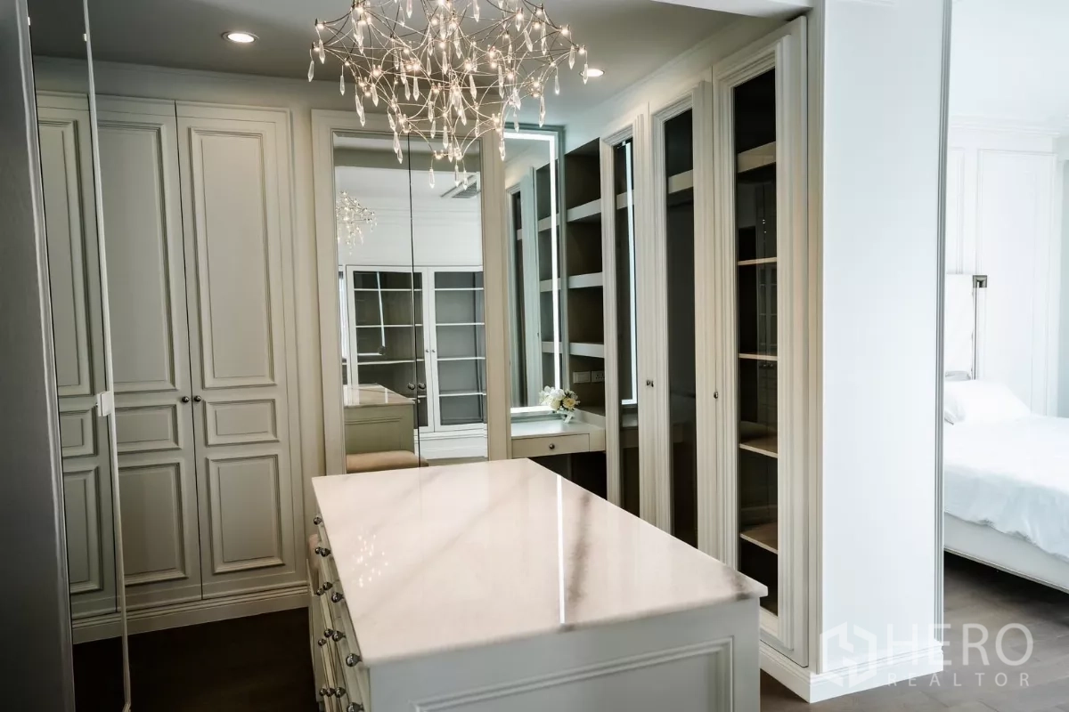 Detached House for rent or sale in Bang Kapi, Bangkok - Alternate view of the walk-in wardrobe with glass-front cabinets and vanity.