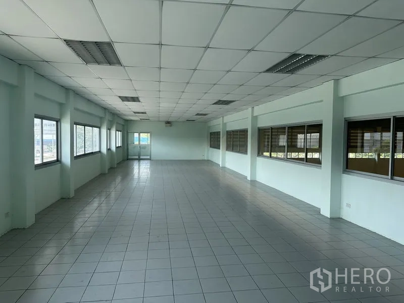 Factory for rent in Chon Buri - Second‑floor open‑plan office with long rows of windows overlooking the factory floor.