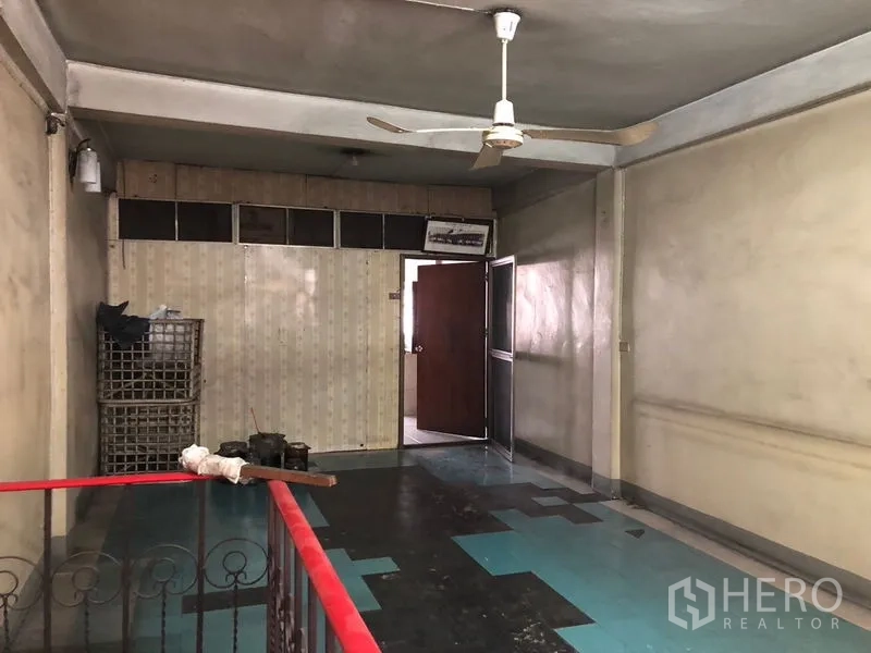 Shophouse for rent - Open mezzanine hall with ceiling fan, patterned flooring and stair railing for flexible workspace.