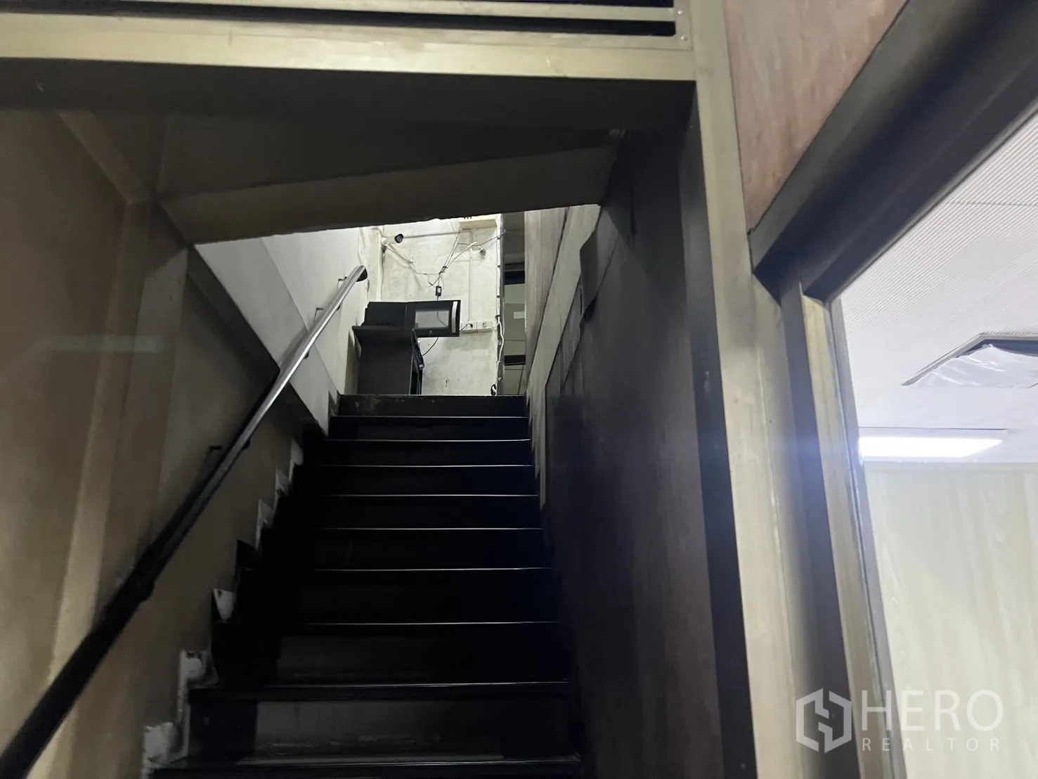 Shophouse for rent - Internal staircase with metal handrail leading to upper floors.