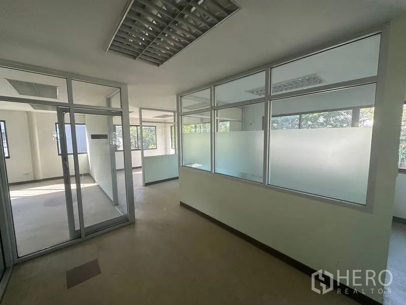 Warehouse for rent in Saphan Sung, Bangkok - Corridor with frosted glass partitions leading to private offices.
