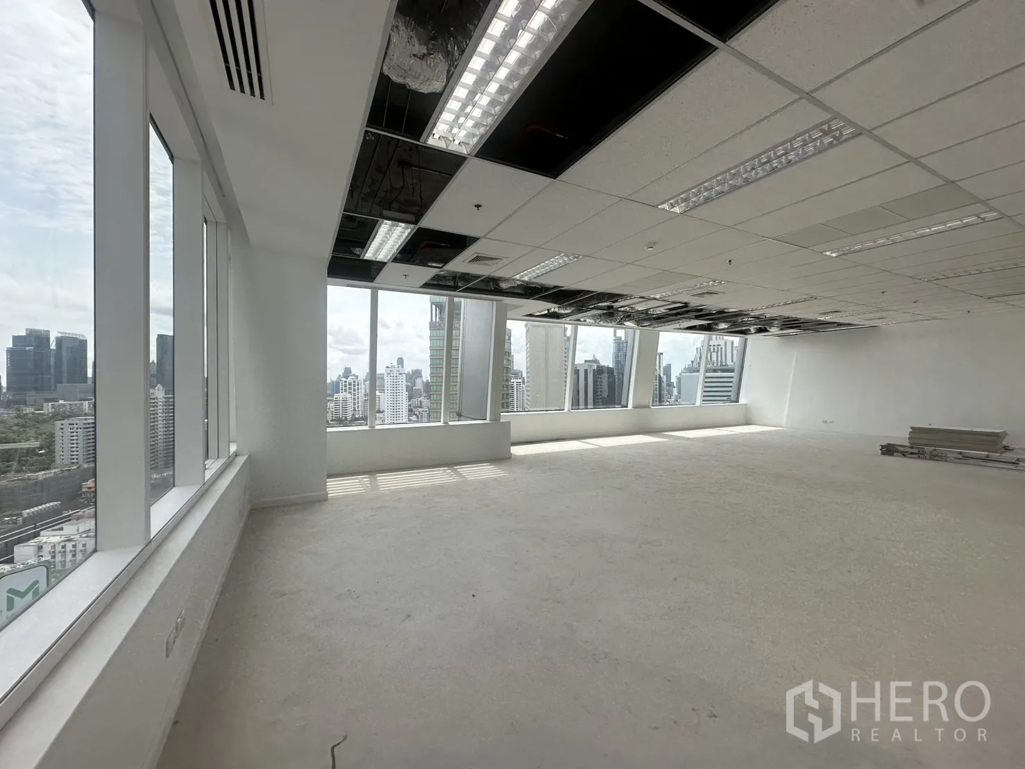 Office Space for rent in Watthana, Bangkok - Wide, uninterrupted workspace bordered by tall windows with skyline outlook.