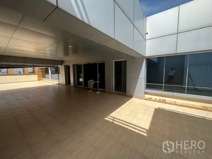 Office Space for rent in Suan Luang, Bangkok - Spacious covered terrace with sliding glass doors and tiled flooring.