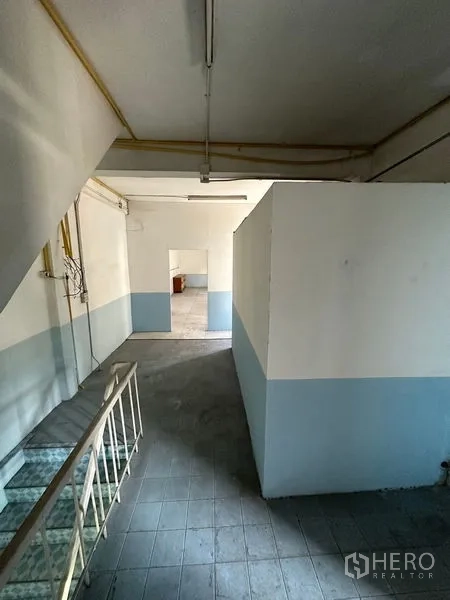 Shophouse for rent in Bang Na, Bangkok - Second-floor corridor with partitioned rooms and natural light.