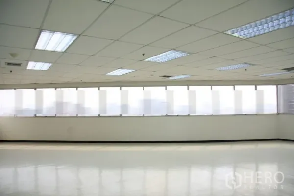 Office Space for rent in Chatuchak, Bangkok - Row of large windows with blinds filling the office with soft natural light.