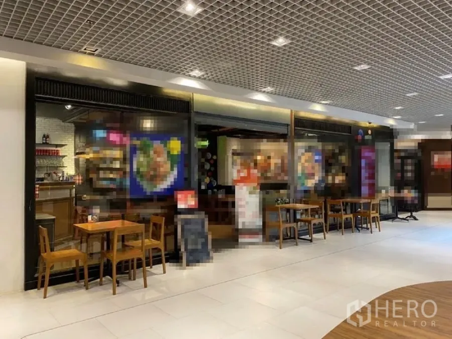 Retail Space for rent in Khlong Toei, Bangkok - Mall corridor retail shop with full glass frontage, warm lighting and café-style tables.