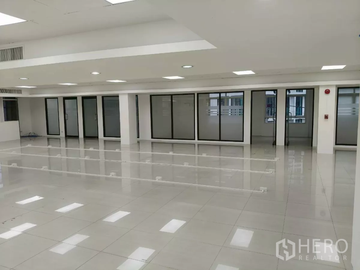Office Space for rent in Chatuchak, Bangkok - Spacious office area with multiple frosted glass doors and polished tile flooring