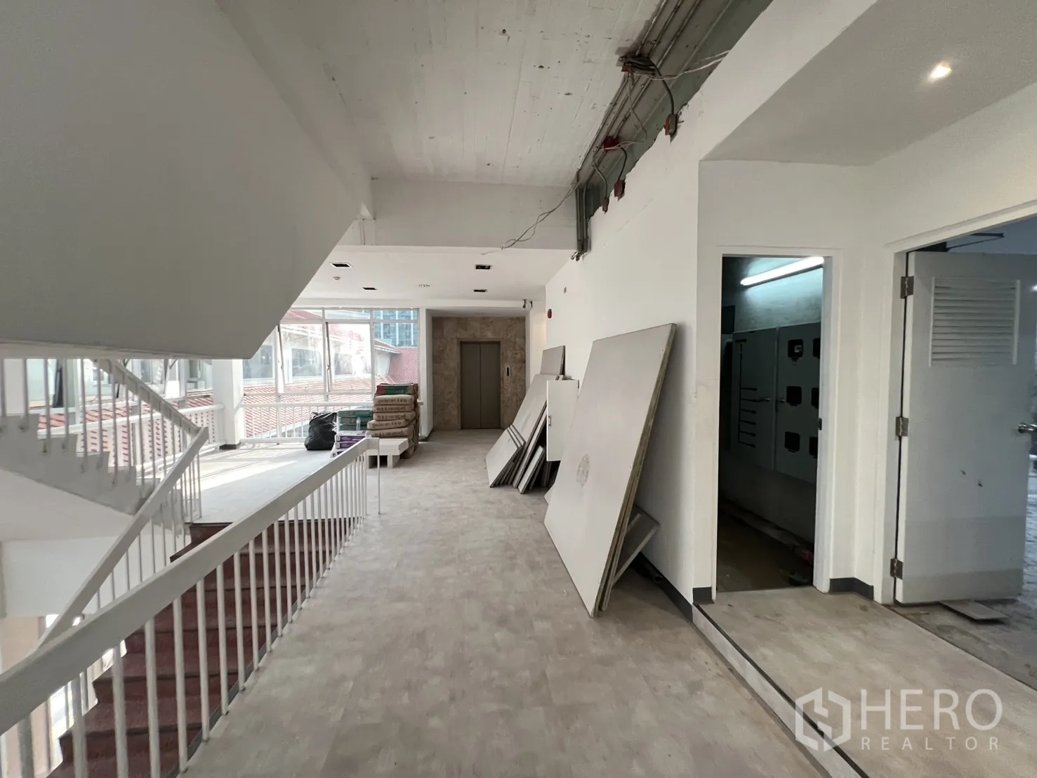 Office Space for rent in Watthana, Bangkok - Lift lobby and stair landing with construction materials, ready for final fit‑out.