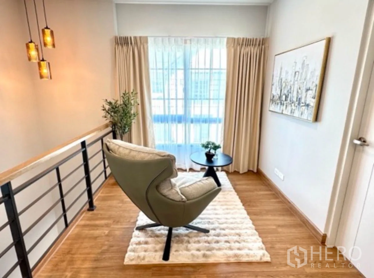 Detached House for rent in Bang Phli, Samut Prakan - Cozy upstairs reading nook with armchair, rug and large window with curtains.