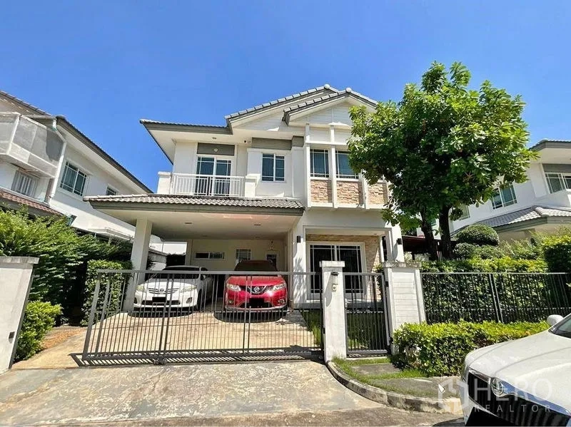 Detached House for sale in Prawet, Bangkok - Front exterior of a two-storey detached house with gated driveway and covered parking.