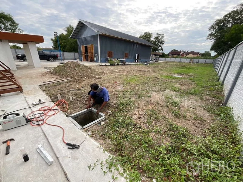 Warehouse for rent or sale in Nong Chok, Bangkok - Expansive yard inside walled compound with concrete paths, offering space for storage or expansion.