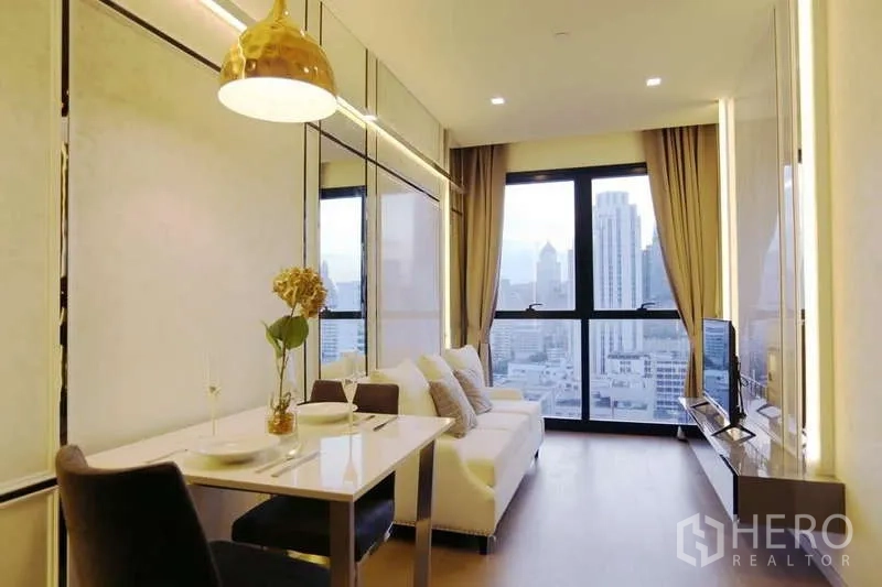 Condominium for rent in Watthana, Bangkok - Long view of dining and living space leading to full-height windows and city skyline.