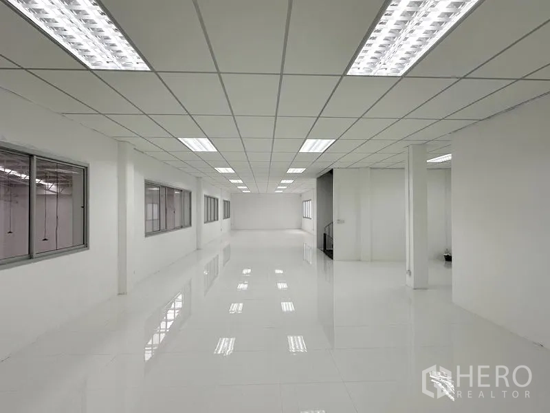 Factory for rent in Pathum Thani - Bright second-floor office space with tiled floors and windows overlooking the factory.