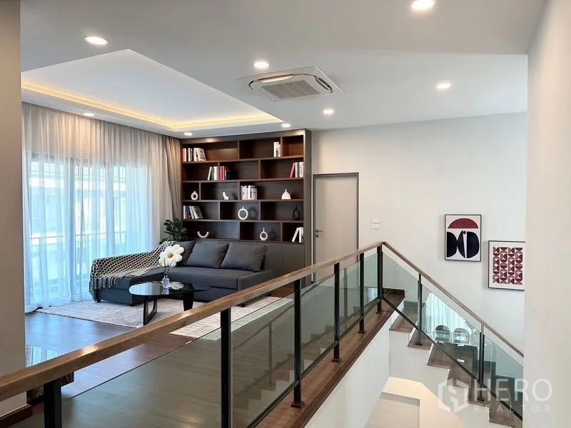 Detached House for rent or sale in Bang Phli, Samut Prakan - Second-floor landing with glass railing and reading lounge.