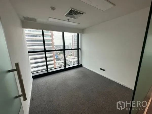 Office Space for rent - Private office room with floor-to-ceiling windows overlooking Bangkok.