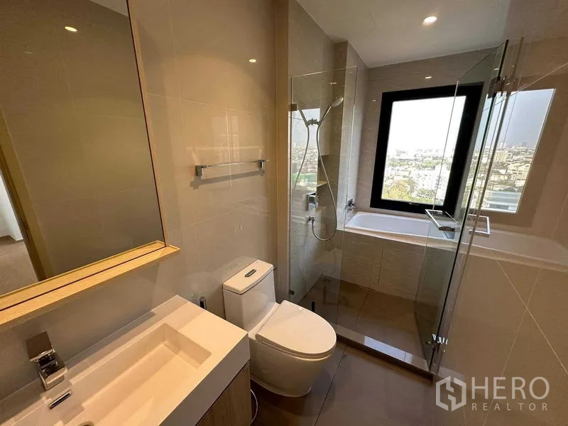Condominium for sale - Contemporary bathroom with glass shower, bathtub and a window framing skyline views.