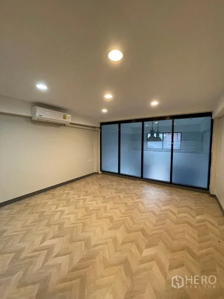 Home Office for rent in Chatuchak, Bangkok - Air-conditioned workspace with herringbone floor and sliding glass doors.