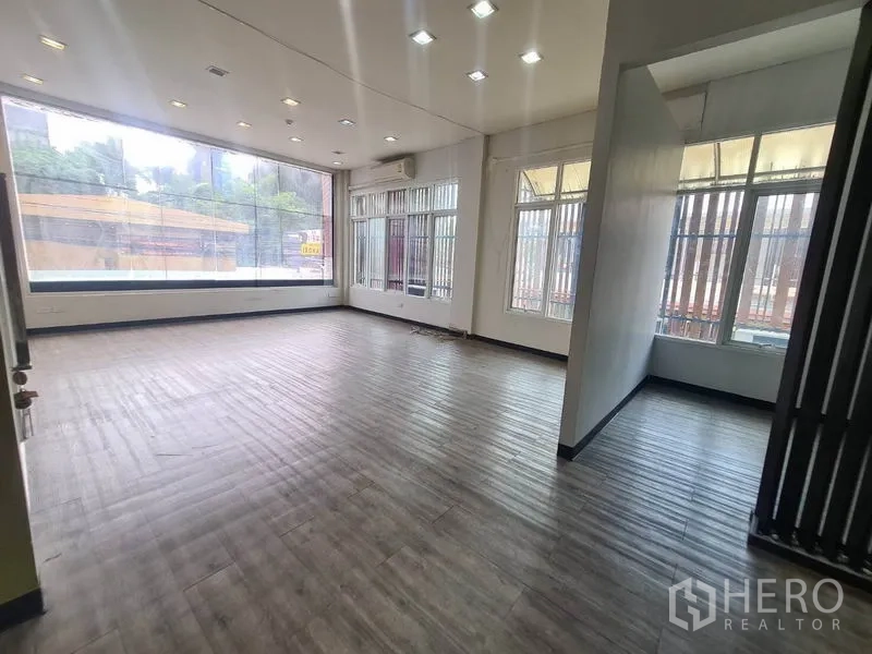 Retail Space for rent in Watthana, Bangkok - Corner retail area with wraparound windows and city street views.