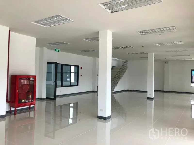 Factory for rent in Wang Noi, Phra Nakhon Si Ayutthaya - Ground-floor office area with staircase, red fire hose cabinet, and ample natural light.