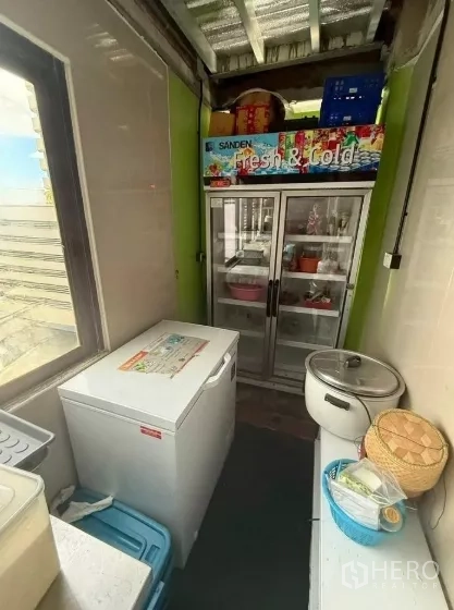 Retail Space for rent in Watthana, Bangkok - Compact cold-storage room with a glass-door refrigerator and chest freezer by the window.