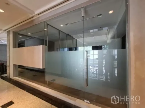Office Space for rent - Glass-fronted office entrance with frosted panels and corridor view.