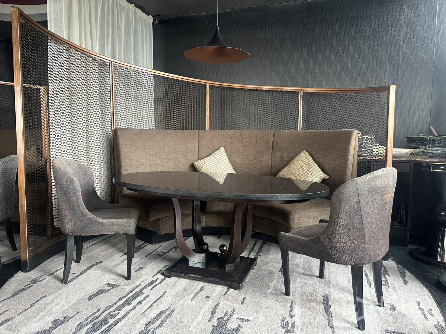 Retail Space for rent in Khlong Toei, Bangkok - Curved booth seating with a round table and mesh privacy partitions.