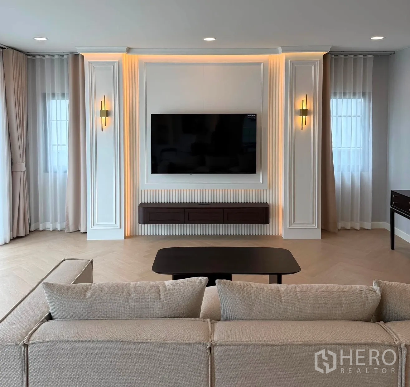 Detached House for rent or sale in Bang Phli, Samut Prakan - Main lounge featuring TV on accent wall and sofa facing a coffee table.