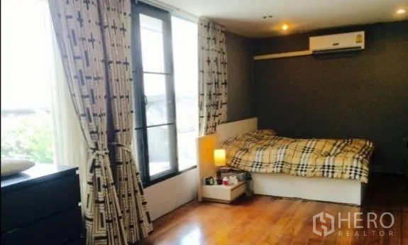 Detached House for rent in Khlong Toei, Bangkok - Cozy bedroom with wooden floor, large windows and air conditioning