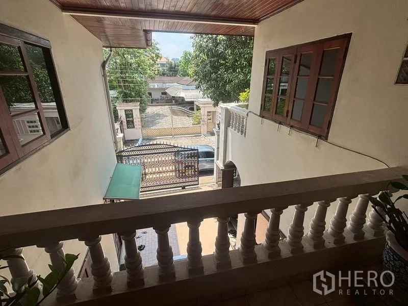 Detached House for sale in Suan Luang, Bangkok - Second-floor balcony looking toward driveway and decorative gate.