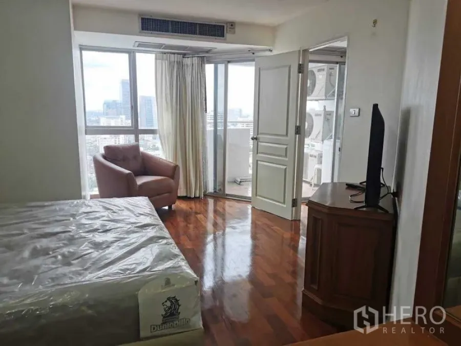 Condominium for rent - Bedroom corner facing the balcony with large windows bringing in natural light.