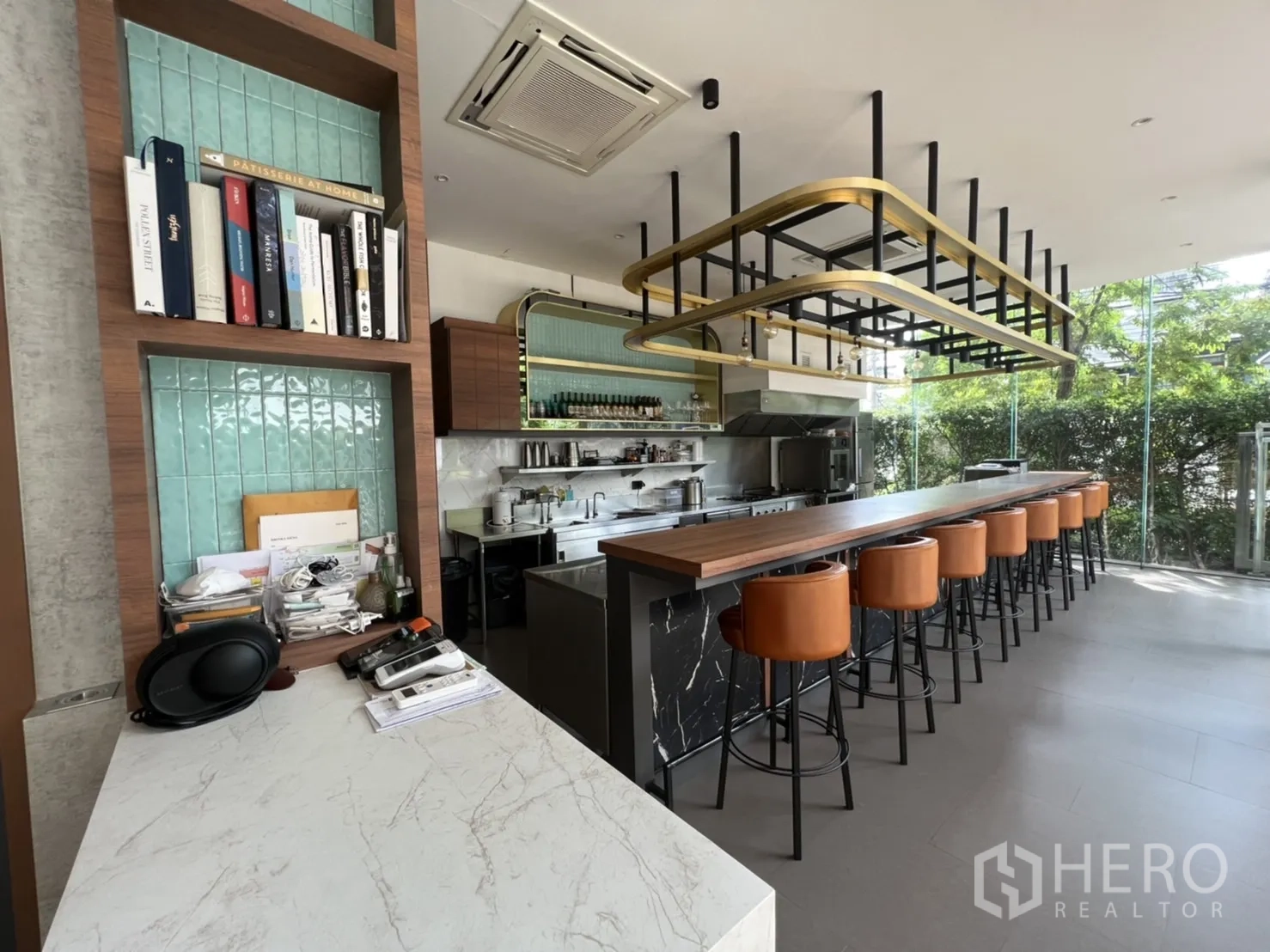 Retail Space for rent in Watthana, Bangkok - Cafe-ready retail interior with long wooden bar, leather stools, open stainless kitchen and floor-to-ceiling glass.