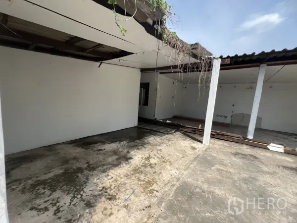 独立式住宅 出租在Phra Khanong, Bangkok - 半覆盖的户外空间，立柱与裸露屋梁，混凝土地面。