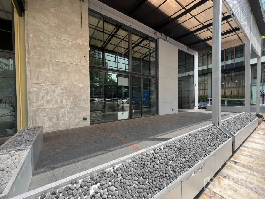 Retail Space for rent in Watthana, Bangkok - Exterior frontage with canopy, planter beds, and double-height windows.