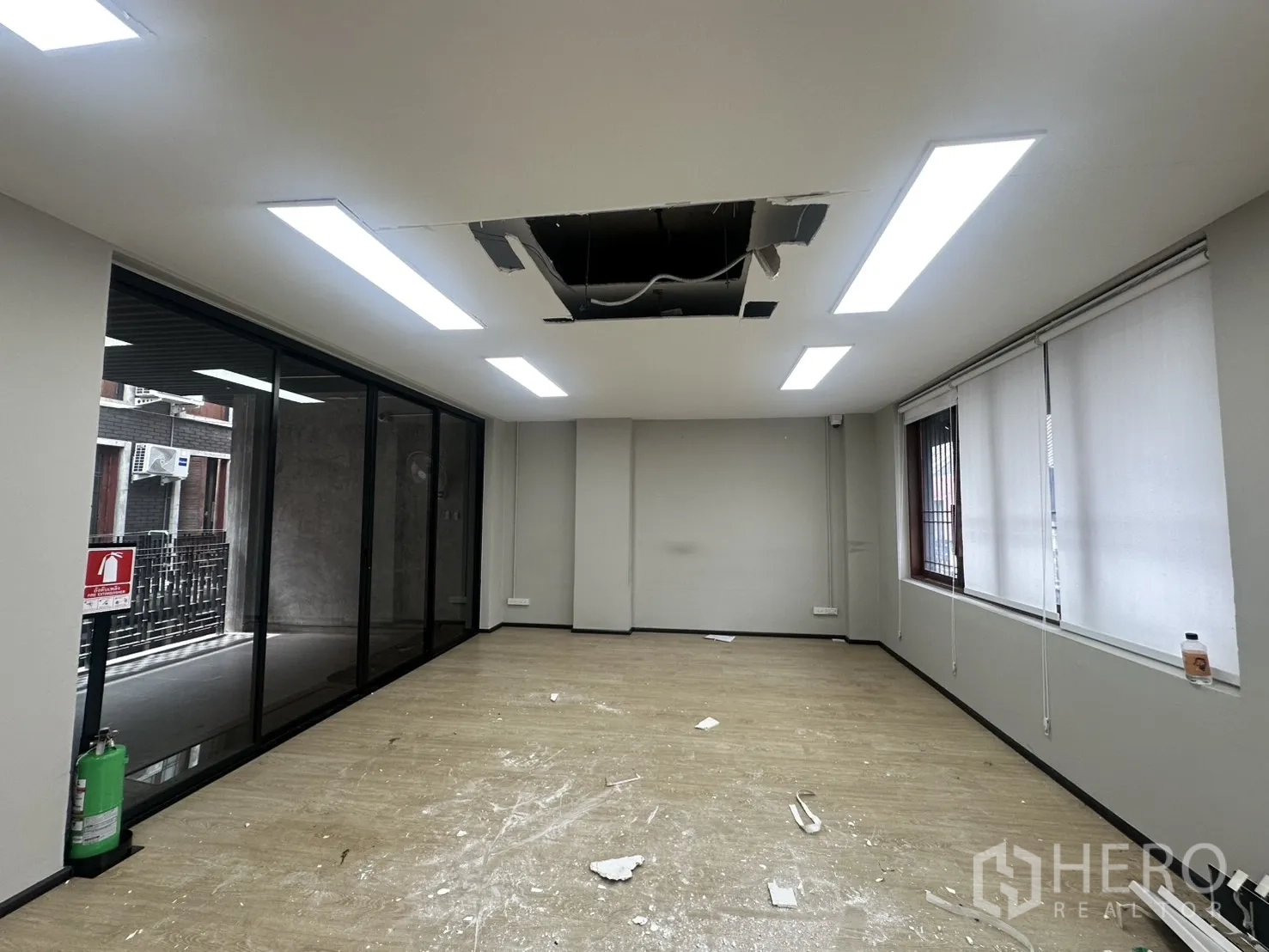Home Office for rent in Pathum Wan, Bangkok - Open office with LED panels, window blinds and partial ceiling works in progress.