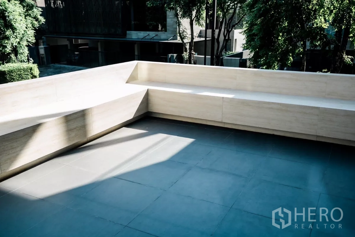Detached House for rent or sale in Bang Kapi, Bangkok - Large private terrace with built-in seating overlooking a leafy residential street.