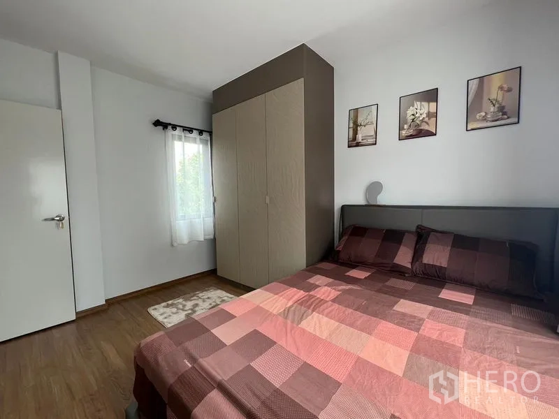Townhouse for rent - Guest bedroom angle showing wardrobe, wall art and natural light.