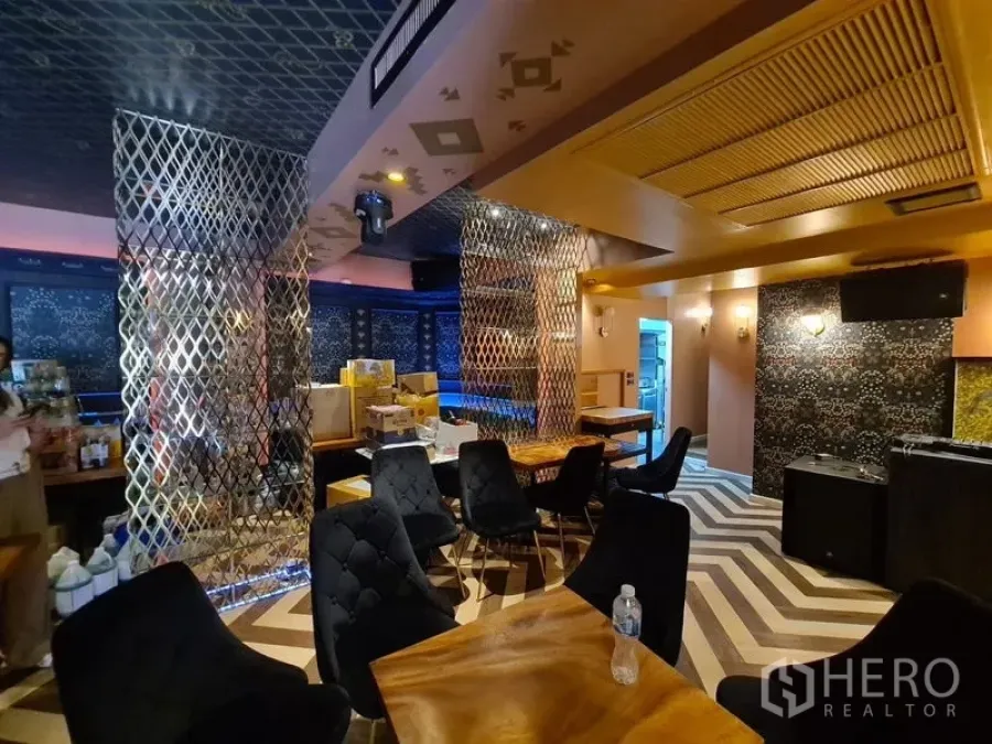 Retail Space for rent in Bang Rak, Bangkok - Lounge area with chevron flooring, plush chairs, wood tables and metallic room dividers.