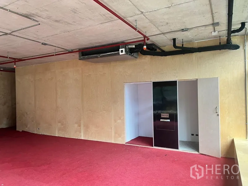 Retail Space for rent in Watthana, Bangkok - Upper floor wall with doorway and built-in panel under exposed ceiling and red carpet.