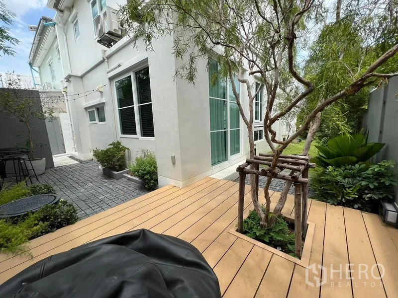 Detached House for rent or sale in Prawet, Bangkok - Private backyard with wooden deck, mature tree and paved side yard.