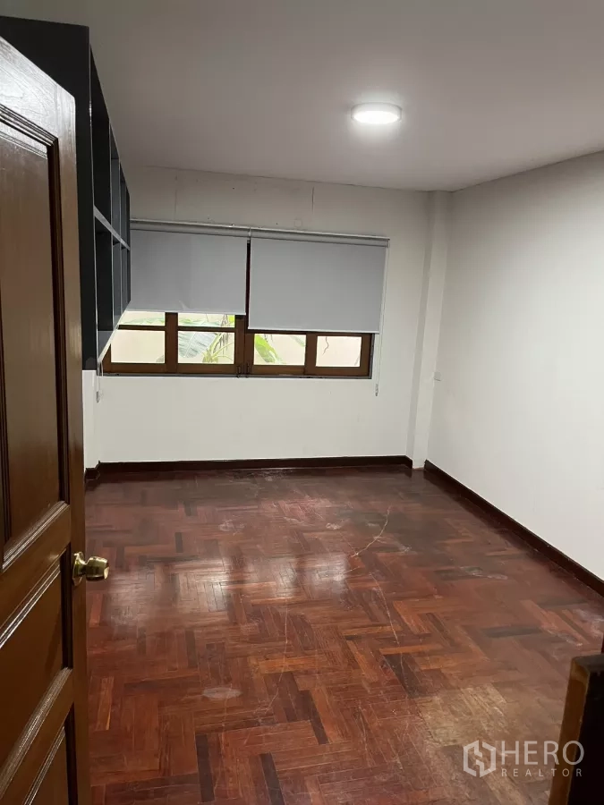 独立式住宅 出租在Watthana, Bangkok - 卧室带木地板、卷帘与横向窗户。