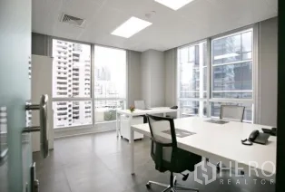 Office Space for rent in Khlong Toei, Bangkok - Corner private office with two desks, large windows, and skyline outlook.