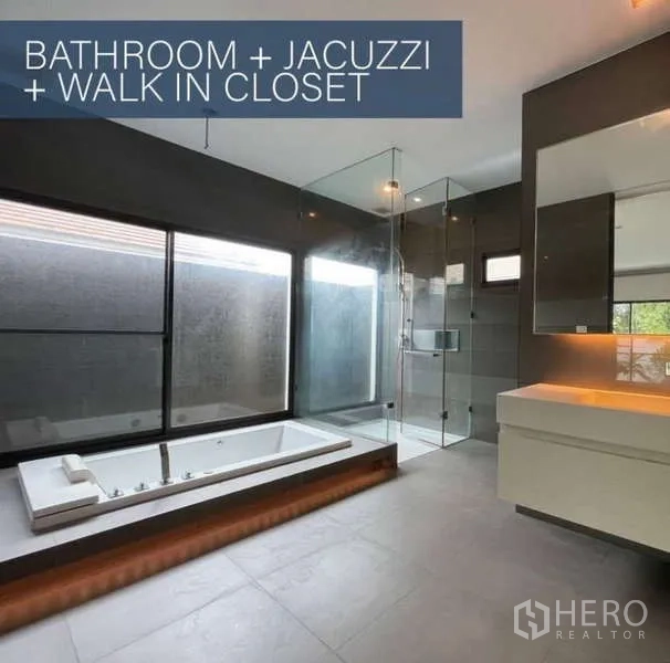Detached House for sale in Khlong Toei, Bangkok - Spacious bathroom featuring a built-in jacuzzi, glass shower enclosure, large windows and vanity.