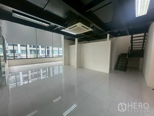 Office Space for rent in Khlong Toei, Bangkok - Spacious work area with staircase to the mezzanine and roller blinds on wide windows.