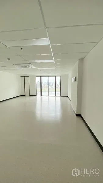 Office Space for rent in Watthana, Bangkok - Open 49 sqm office with large end windows bringing natural light into the workspace.