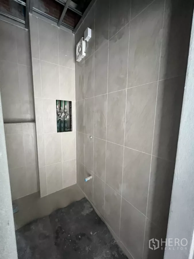Retail Space for rent in Khlong Toei, Bangkok - Newly tiled restroom under construction with ventilation fan installed.