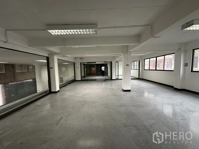 Office Space for rent in Khlong Toei, Bangkok - Large open office with windows on two sides and internal glass partitions.