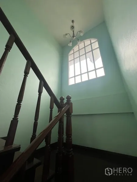 Detached House for rent in Bang Na, Bangkok - Stairwell with tall arched window and chandelier