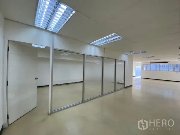 Office Space for rent in Watthana, Bangkok - Glass-partitioned offices dividing the open workspace into separate rooms.