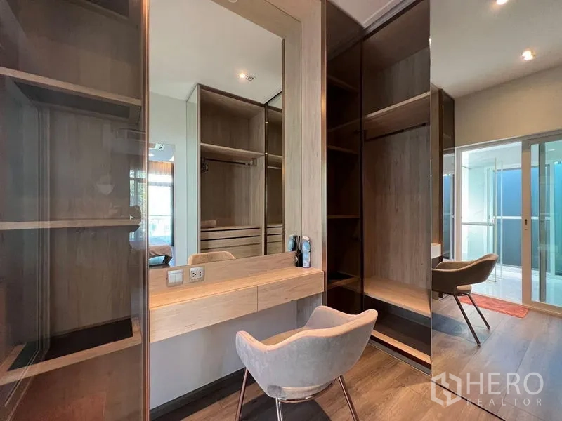 Detached House for sale - Walk-in closet with dressing table, glass cabinetry and sliding door to bathroom.